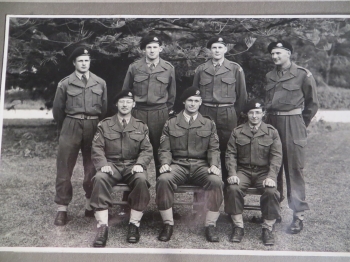 A sergeant in the tank regiment (sitting, in the middle)